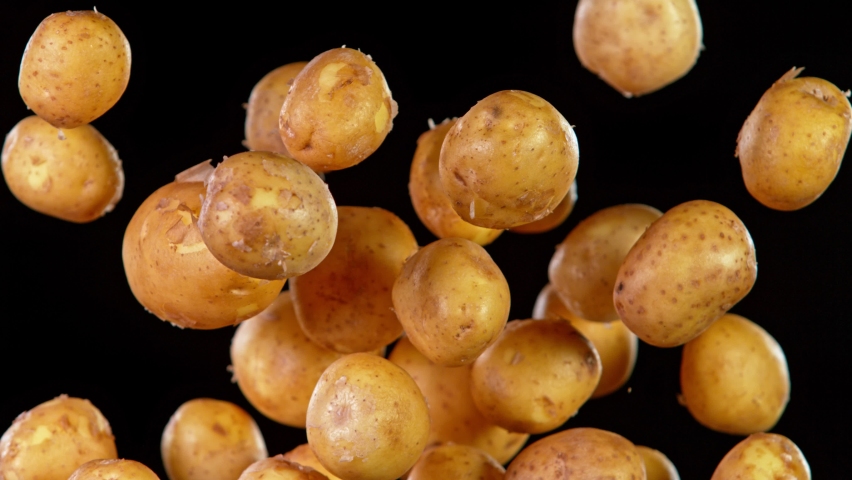Super Slow Motion Shot of Flying Potatoes Isolated on Black Background at 1000 fps.