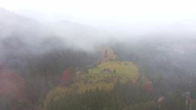 Rainy foggy and gray weather in the mountain valley of the Carpathians in Ukraine in small village Dzembronya. Aerial UHD 4K drone realtime video, shot in 10bit HLG and colorized
