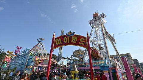 Incheon, South Korea - Oct 12 2019 : Tourists traveling with playing amusement park with viking, ferris wheel, carousel at Wolmi theme park