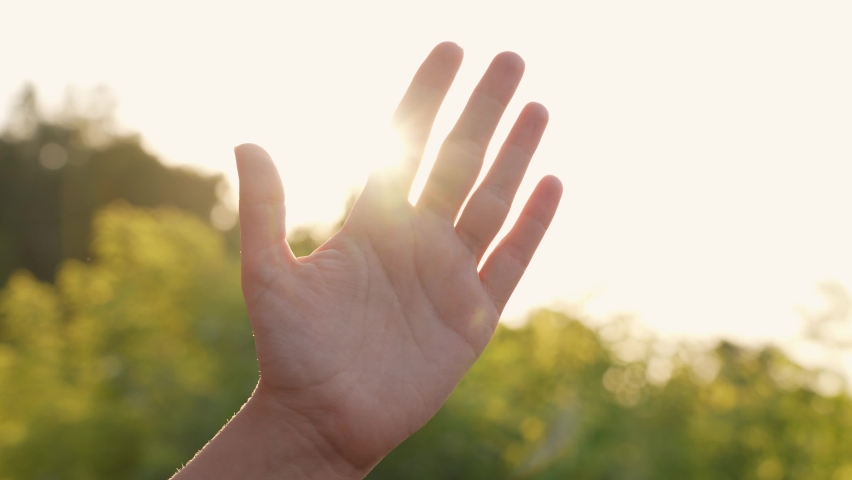One female hand showing Peace or Victory gesture outdoors isolated on sunny sunset or sunrise sky nature background. Close-up view 4k video footage of hand of woman with two fingers raised up Royalty-Free Stock Footage #1077178232