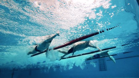 Professional swimmers competition concept. Swimming competition filmed underwater