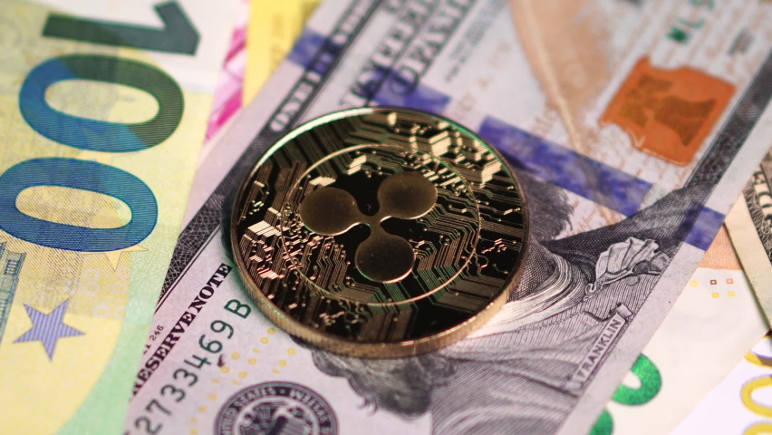 Ripple Coin on Dollar and Euro Cash Paper Banknotes Close Up. Cryptocurrency and Digital Payment Network XRP, Full Frame