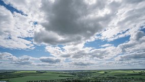Blue sky white clouds background timelapse. Beautiful weather at cloudy heaven. Beauty of bright color, light in summer nature. Abstract fluffy, puffy cloudscape in air time lapse. Video loop