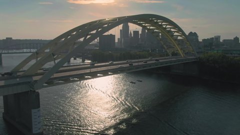Aerial: Freeway traffic crossing the Daniel Carter Beard Bridge over the Ohio River. With the city skyline. Cincinnati, Ohio