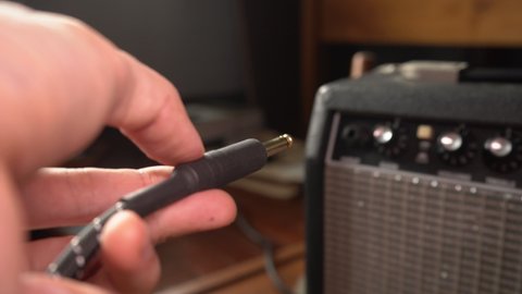 Plugs Guitar Cable Into Guitar Amplifier Stock Footage Video (100% ...