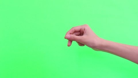 Woman hand doing sprinkling gesture on green screen background. Female hand adds salt to dish. Isolated on chroma key background.