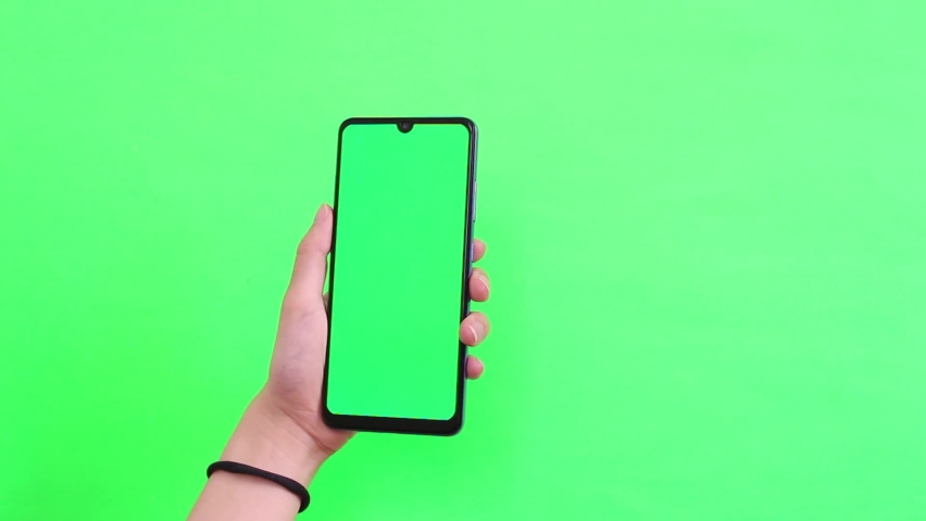 hand holding mobile phone on white background with green screen ...