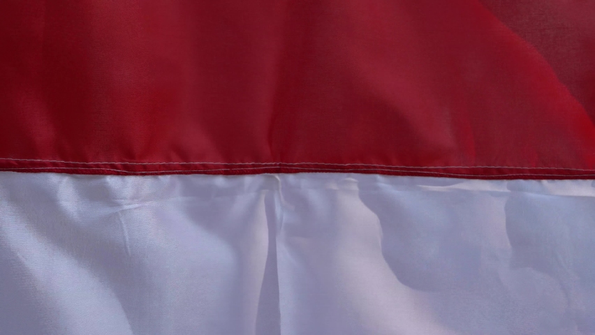 Towards the 76th independence day of the republic of indonesia, many red  and white flags and their decorations are sold on the side of the highway.  this flag is widely installed in front of homes.