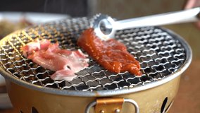 Korean and Japanese traditional grilling styles that are called Yakinikupork. Pork steaks and bacon on a shallow depth of field in this 4k clip