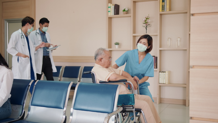 Asia sick old people and carer worker woman hold hand help smile talk stress relief relax wear face mask at clinic. Assisted living rehab staff work in life heal aging man give hope, advice or trust. | Shutterstock HD Video #1077237167