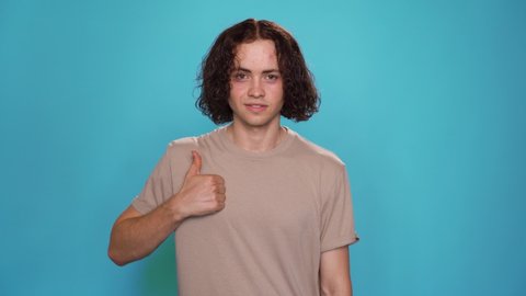 Portrait of Handsome Guy says Believe in yourself for people who are deaf and hard of hearing. Motivational phrase on American Sign Language ASL 