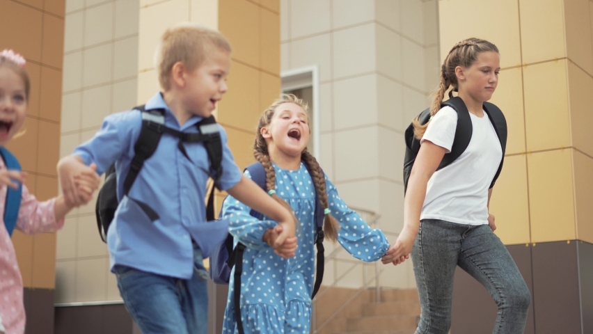 Child run to school with backpack. Back to school. Happy child run with backpack. School education. Child learning after lockdown. Happy family run through schoolyard. Joy of learning. Child to school | Shutterstock HD Video #1077252290