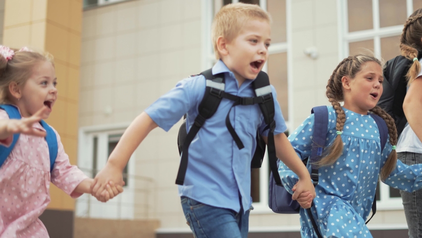 Child run to school with backpack. Back to school. Happy child run with backpack. School education. Child learning after lockdown. Happy family run through schoolyard. Joy of learning. Child to school | Shutterstock HD Video #1077252290