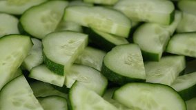 Cucumber salad. Pour olive oil on sliced cucumbers, rotation. Healthy food concept. 4K UHD video