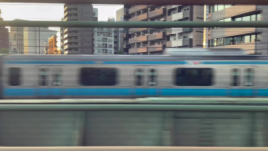 TOKYO, JAPAN - JULY 2021 : Sunset cityscape of Tokyo. Tracking view from train. View of buildings and street at central downtown area around Shinagawa station. | Shutterstock HD Video #1077257009