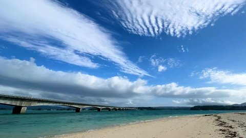 NAKIJIN VILLAGE, OKINAWA, JAPAN - JUNE 2021 : View of Kouri beach (Ocean or sea). Wide view, time lapse shot in daytime. Holiday, vacation and resort concept shot.