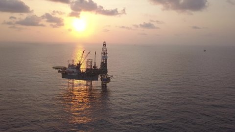 Aerial view of offshore jack up drilling rig during sunset - oil and gas industry
