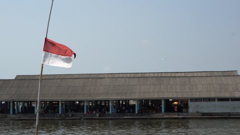 Jepara, Indonesia - August, 2021 : Indonesia's dirty and shabby red and white flag is still flying in the spirit of coloring the spirit of the 76th Independence Day of the Republic of Indonesia