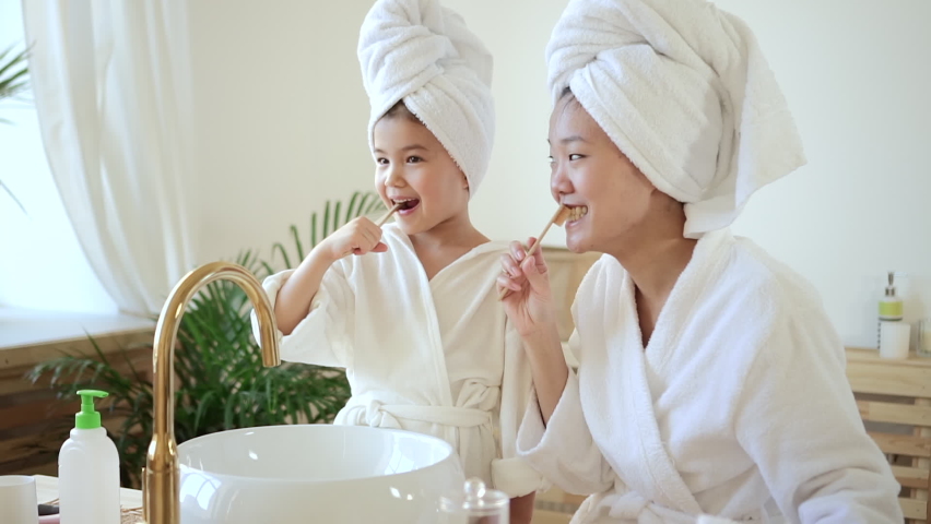 Cleaning teeth mother and daughter in bathroom daily routine Spbd Royalty-Free Stock Footage #1077283556