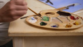 Art education for kids child mixes green paint on palette Spbas