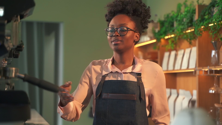African-American woman barista makes coffee with machine Spbas Royalty-Free Stock Footage #1077283616