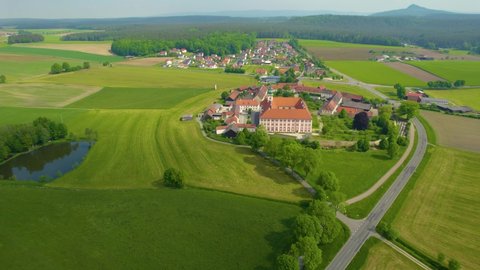 Aerial around the International meeting monastery Speinshart in Germany, Bavaria on a sunny day in spring.