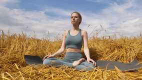 girl practices yoga in a wheat field