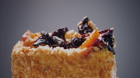 Close-up frame of dried fruits in a cake. Dried fruits and nuts shimmer on top of a delicious cake.
