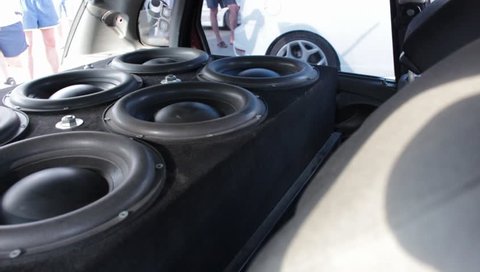 Multiple subwoofers in a car close up. Extremely LOUD Car Audio. Sound Quality Loud. Competitors compete against one another to see who has the loudest car stereo system.