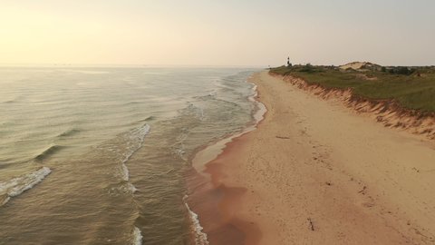 Establishing shot  of the shore of Lake Michigan. Sand dunes, beach at sunset. Ludington State Park, Michigan state, United States of America. Midwestern Aerial  landscape. View from above, fly over. 