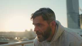 Athletic middle aged man dressed in activewear relaxing outdoors after fast jogging. Bearded man stopping to take a deep breath during morning run on street. - Powered by Shutterstock - Get 15% off with code: PIKWIZARD15
