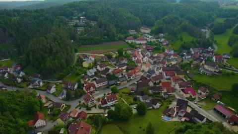 Aerial view of the village Obertrubach in Germany, on a cloudy day in spring.