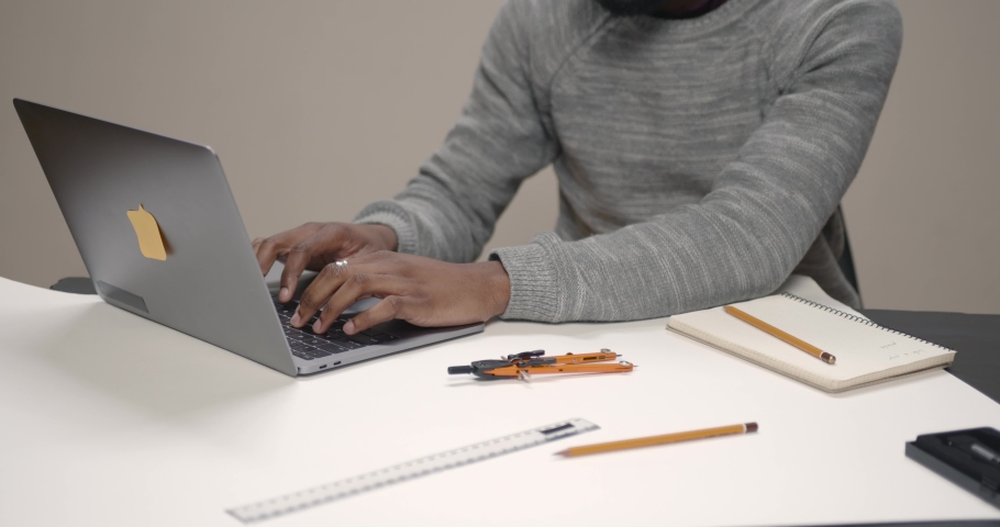 Image of african american businessman working on his laptop