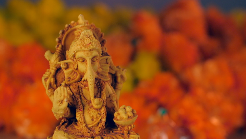 Water is being poured on a clay statue of Lord Ganpati during Ganesh Visarjan. Hindu God Ganesh in a traditional Puja ceremony - Indian Hindu festival. Rituals and Prayers Royalty-Free Stock Footage #1077320780