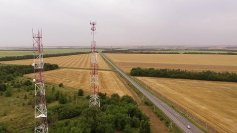Drone flies over telecommunication towers in the countryside