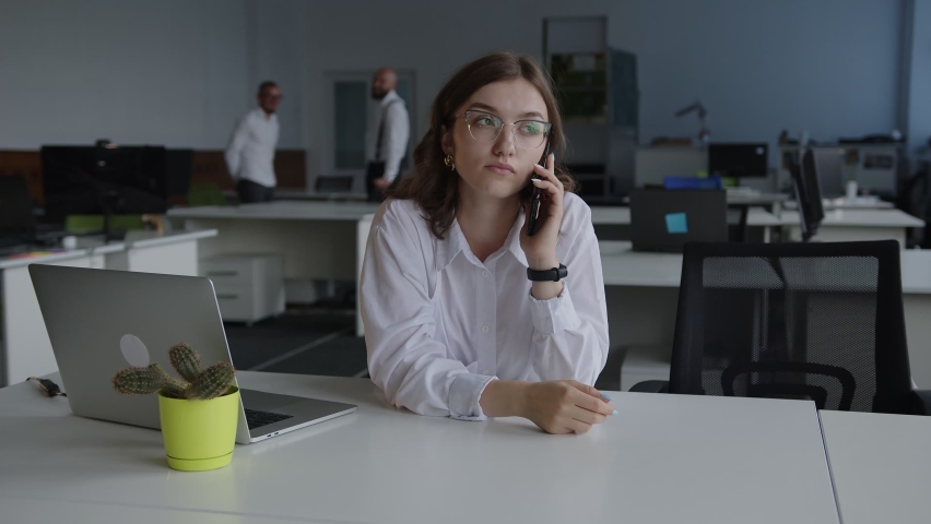 Lady talks in her lunch hour, company, white shirt, black glasees