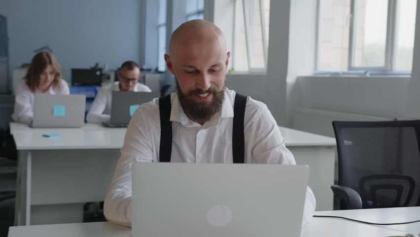 Handsome man look on the computer and talk to the stuff
