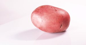 Rotated pink potato isolated on white background