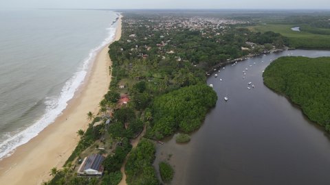 Aerial view of the village of Caraíva in Porto Seguro in southern Bahia. Tropical paradise with boats and umbrellas in tropical Brazil sunset.