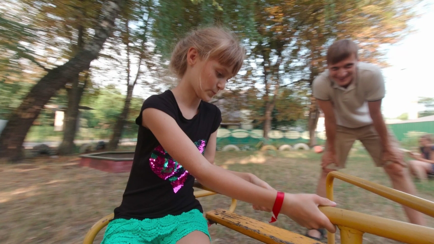 Girl singing in the playground with family