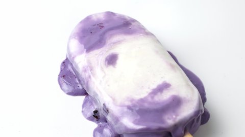 Lavender purple cold ice cream melt on white background. 4K video of ice cream.