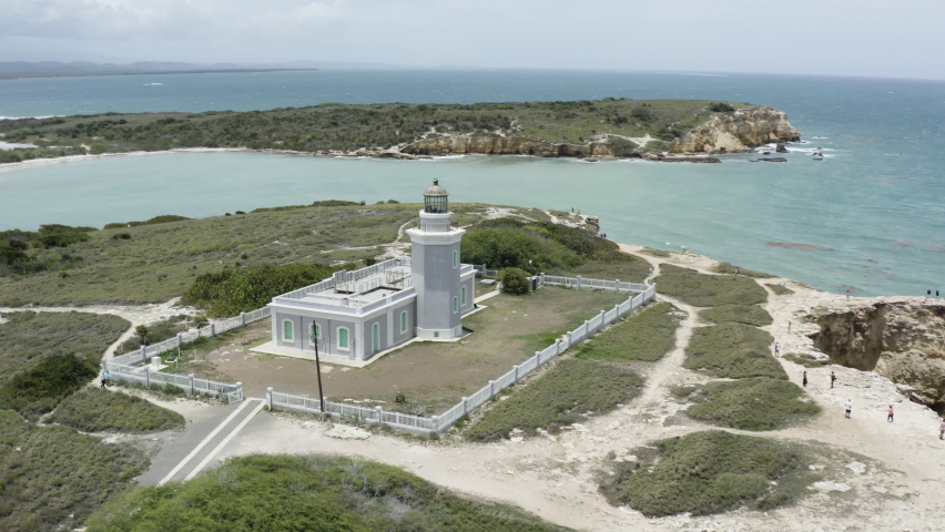 Point of interest aerial shot of the Cabo Rojo Faro Morrillos Lighthouse Puerto Rico on top of limestone cliffs overlooking the Caribbean