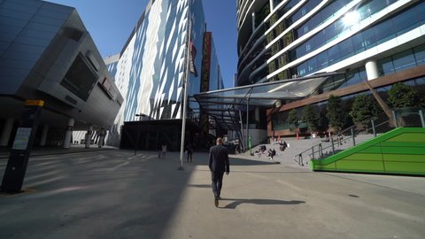 Melbourne , Australia - 08 01 2021: Businessman walking through Melbourne office district, follow up view