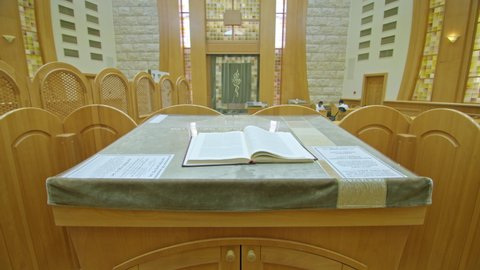 Kryvyi Rih, Ukraine - 08.03.2021 Torah in the synagogue. the meaning of religion for the Jews. The book lies in the foreground, in the background the image of symbolism. wide-angle shot.
