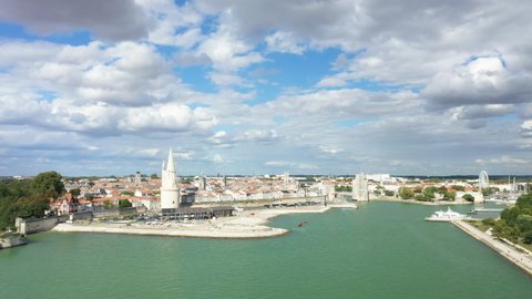 The entrance to the port of La Rochelle in Charente-Maritime, New Aquitaine, France, in summer and by drone on a sunny and cloudy day.