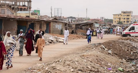 ACCRA, GHANA - 20 JUL 2021: Muslim area Nima Accra Ghana homes walk path Africa. West Africa on the Atlantic ocean. Many towns, villages communities polluted by trash, garbage and sewage.