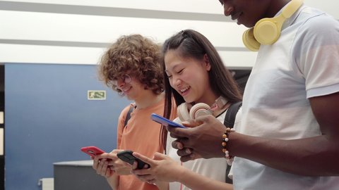 Group of students using a cell phone. Young people in high school connected by technology. Video Stok