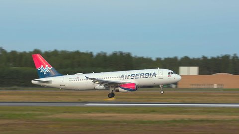 Oslo Airport Norway - August 6 2021: airplane airbus 320 air serbia arrival landing ambient sound