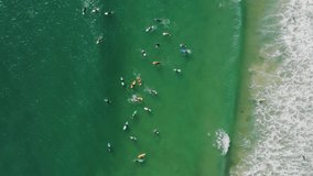 Baleal, Portugal, Europe. Aerial footage of surfers floating on waves. People swimming with SUP boards as seen from top. High quality 4k footage