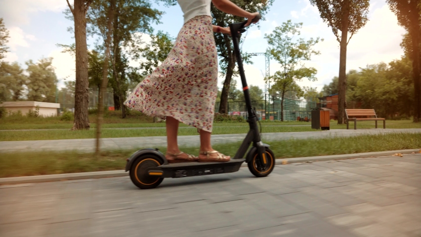 Driving Ecology Transportation. Woman Ride On Electric Scooter Mobility. E-Scooter Rider Rent Personal Eco Transport. Girl Drive Electric Scooter In City.Urban Style Riding Ecological Transport Travel | Shutterstock HD Video #1077362774